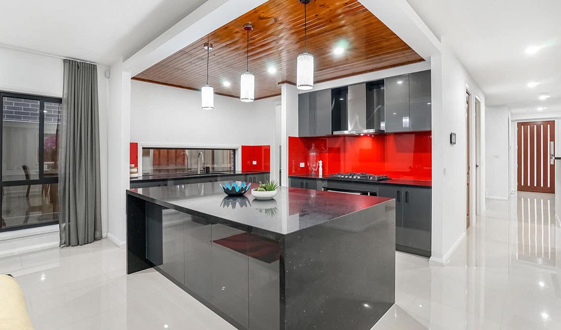 stunning kitchen design with Red and black color scheme and large black color countertop 