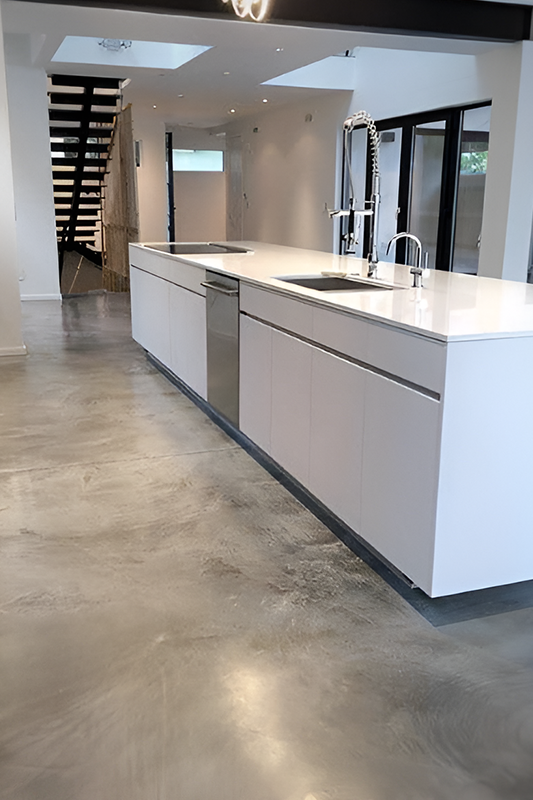 Concrete flooring paired with white cabinets 