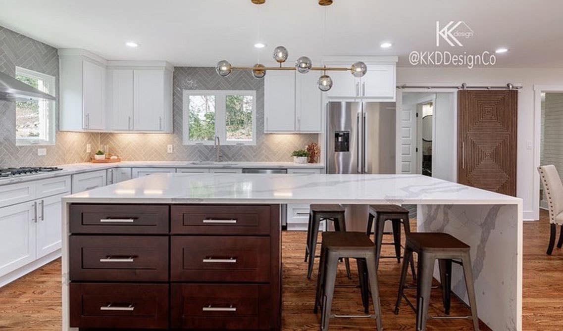 Two tone kitchen with white cabinets and functional island with quartz countertop, SPC Flooring 