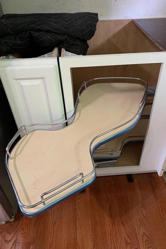 White kitchen cabinet with the rotating shelves