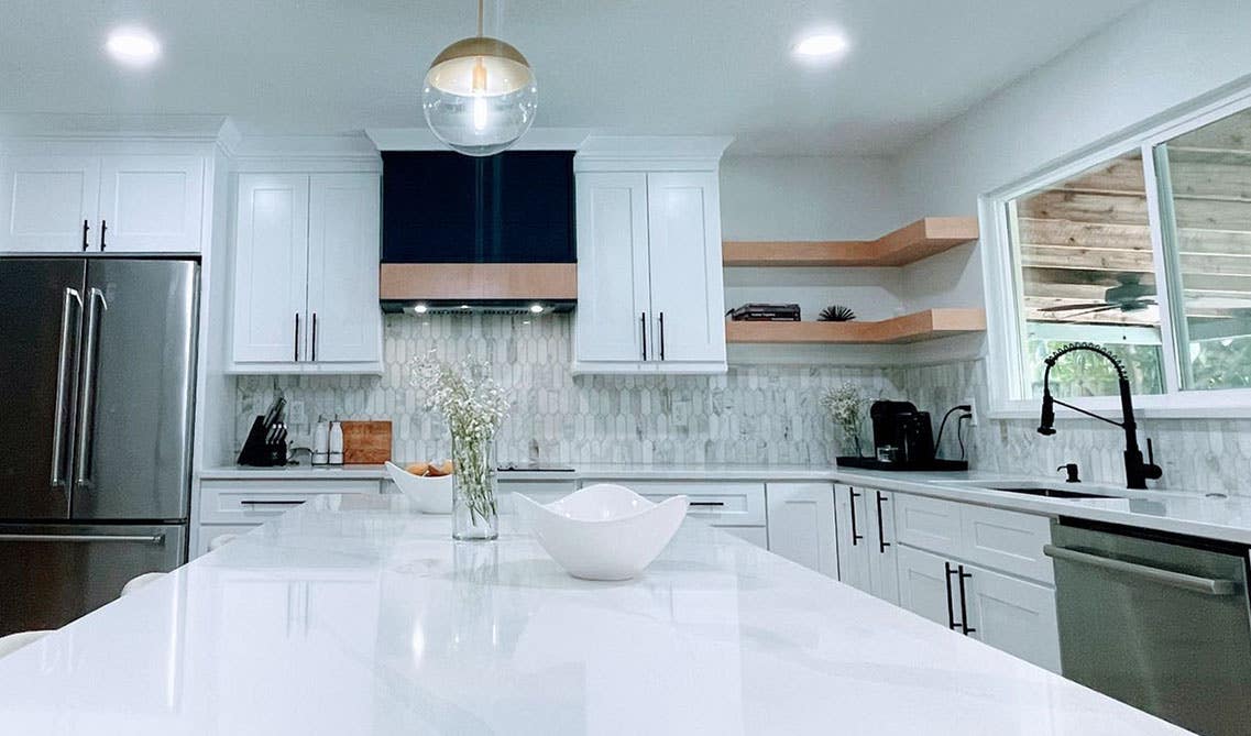 Kitchen white shaker cabinets and Corner shelves, large island with marble countertop