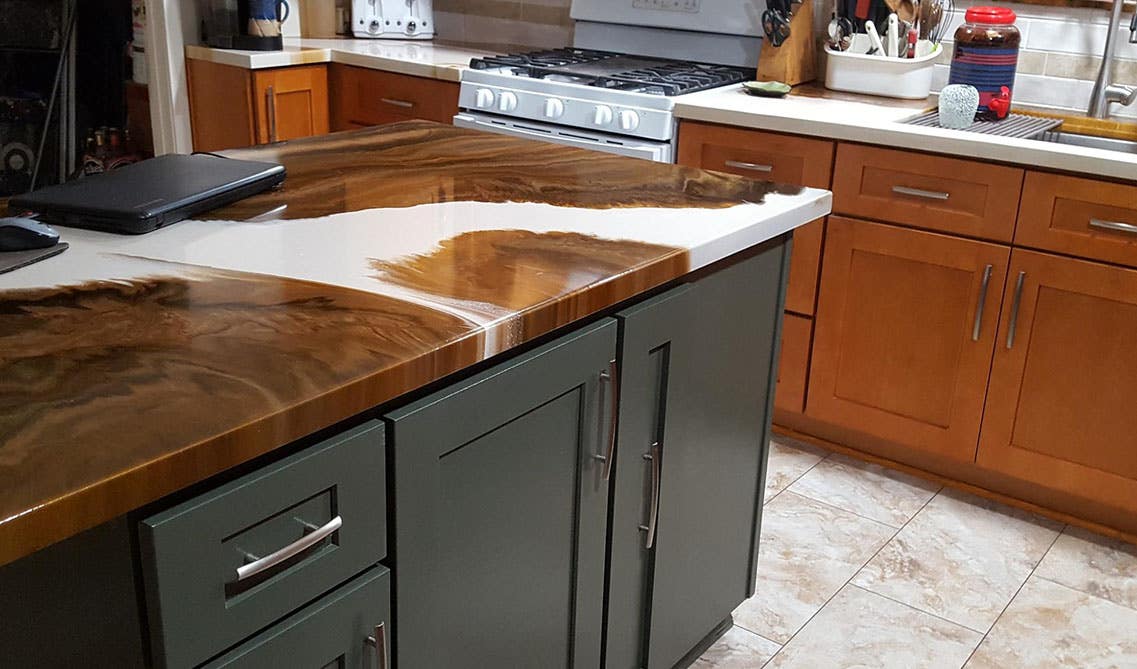 Granite countertop paired with gray shaker island cabinets