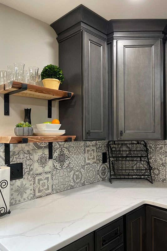 rustic Driftwood Grey cabinet with cove crown molding, pattern tile backsplash, floating shelves and quartz countertop