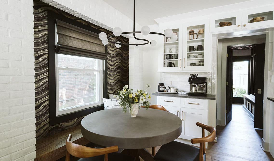 cozy seating area beside the window and glass front cabinets