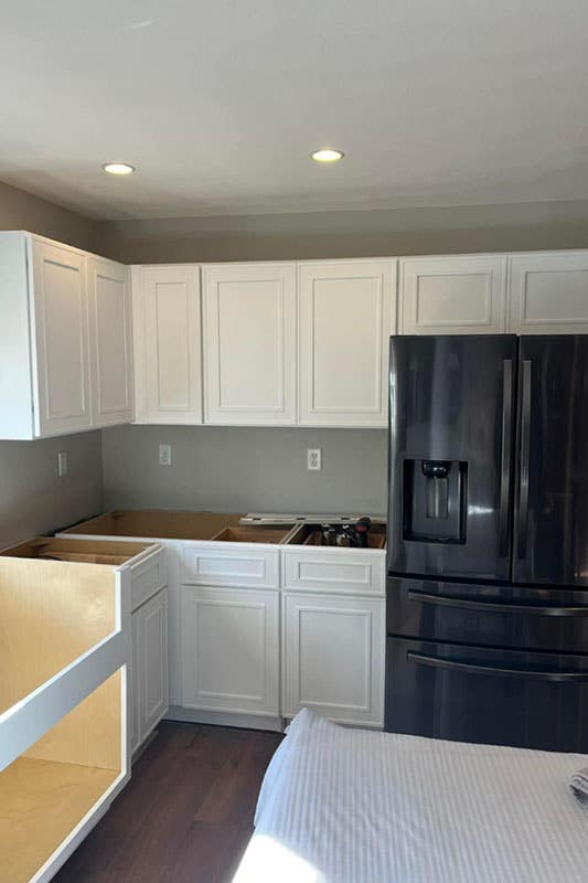 Craftsman White Shaker Cabinet and Black Fridge 