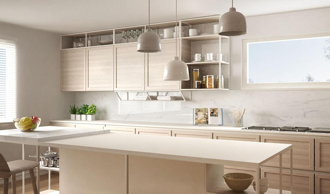 Stylish kitchen with Cream-colored shaker-style cabinets, marble tile backsplash, Large island, and pendent lights 