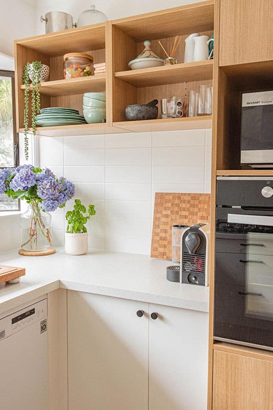 Wood Cabinets with subway tiles and white countertops and open shelving design kitchen