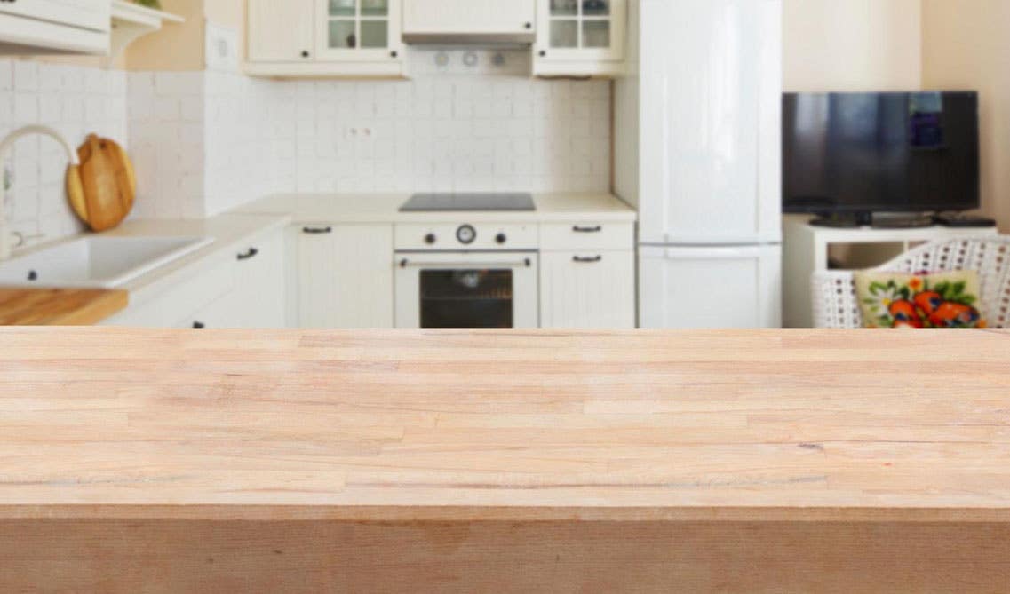 Cream cabinets with Natural wood countertops 