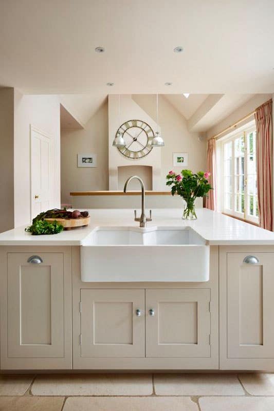 Creamy Beige kitchen cabinet island with undermount farmhouse sink