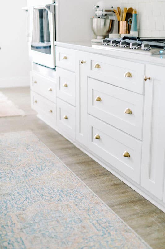 Cup Cabinet Pulls on white cabinets and spc flooring 