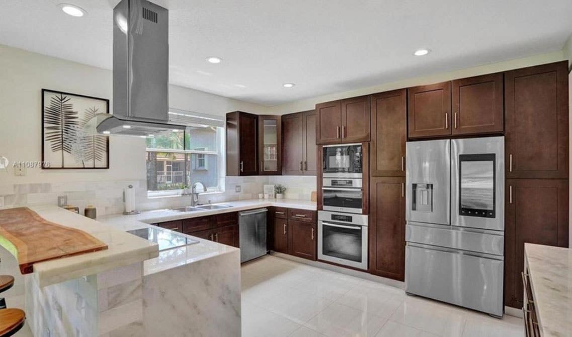 Contemporary Kitchen with dark wood cabinets, marble countertop and stainless steel appliances 