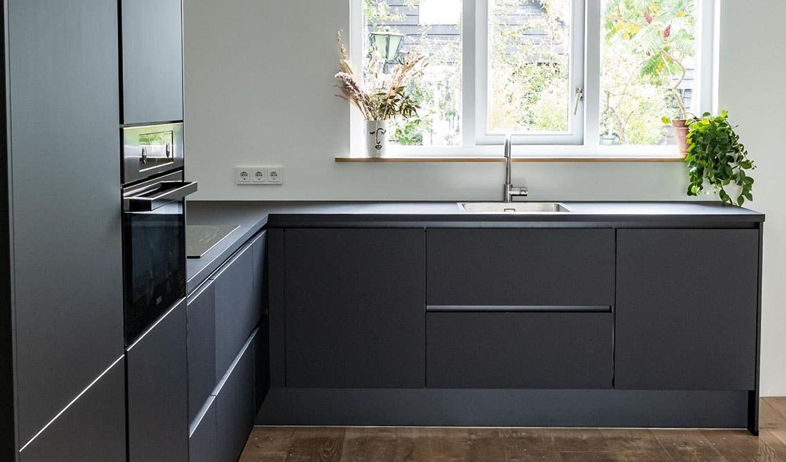 Black Slab Kitchen Cabinets with black countertop, stainless steel sink, and spc flooring