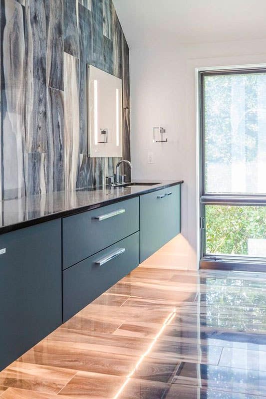 Dark floating bathroom vanity with LED lighting