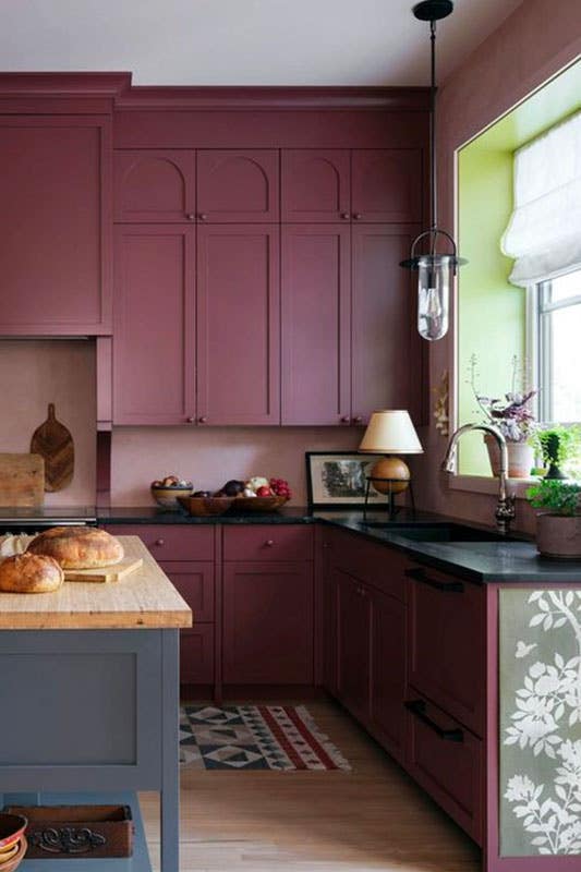 Deep plum kitchen cabinets with black countertop