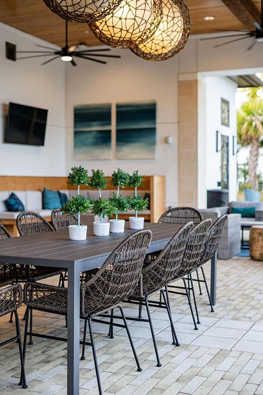 Dining Space in outdoor kitchen, pendent lights and tile flooring