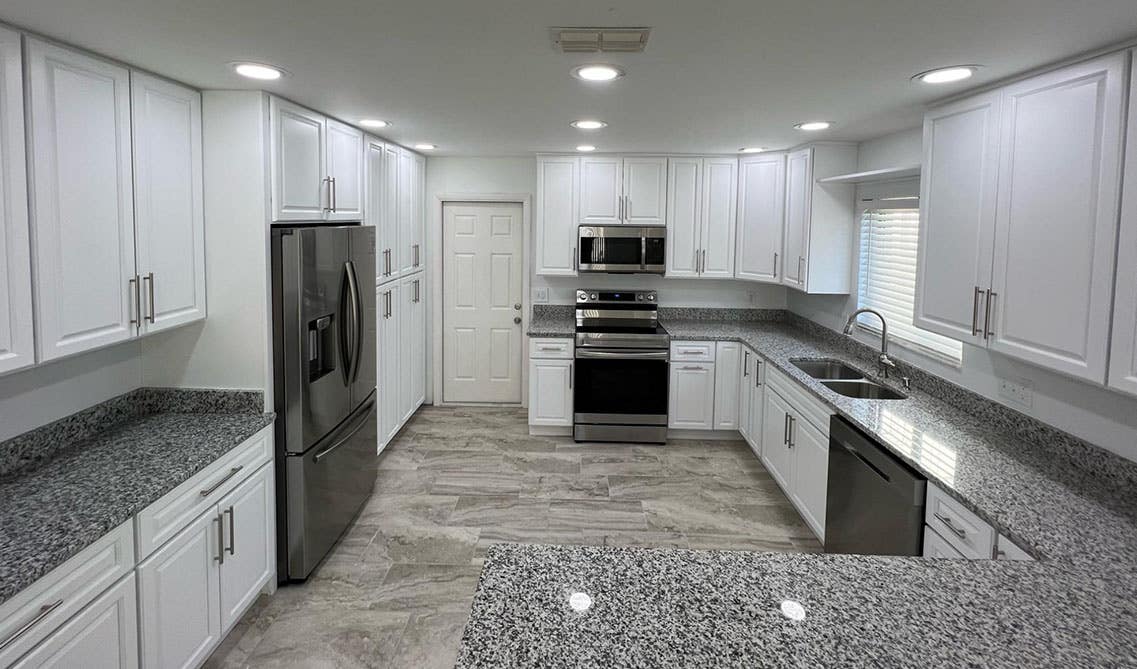 kitchen with white cabinets, quartz countertop and Directional Downlights