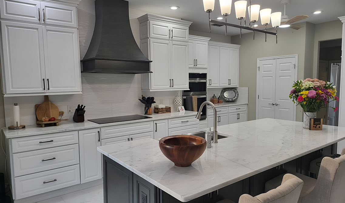 Black range hood paired with white kitchen cabinets