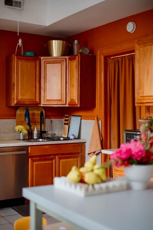 Kitchen design with brown cabinets with terracotta-colored walls