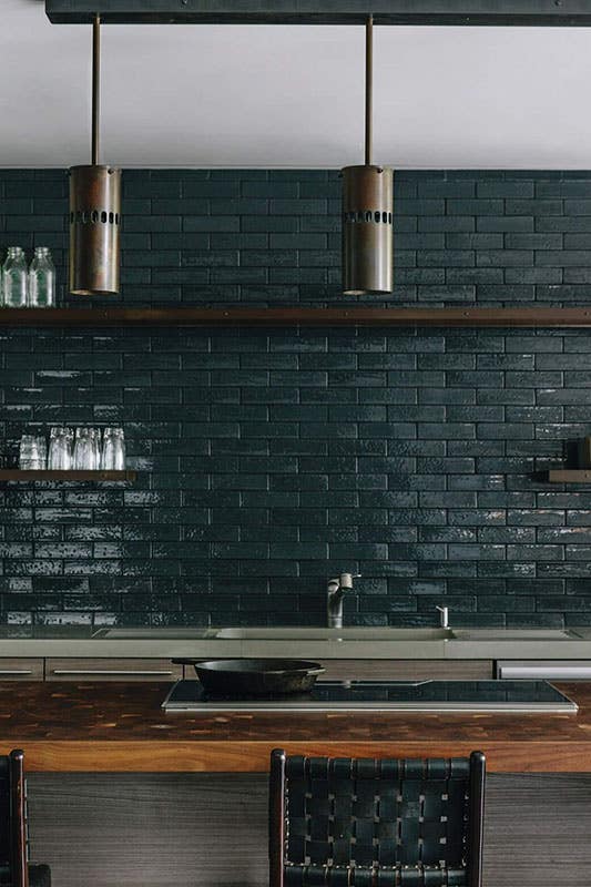 modern kitchen design featuring emerald green subway tile backsplash, minimalist style, large center island and open shelving