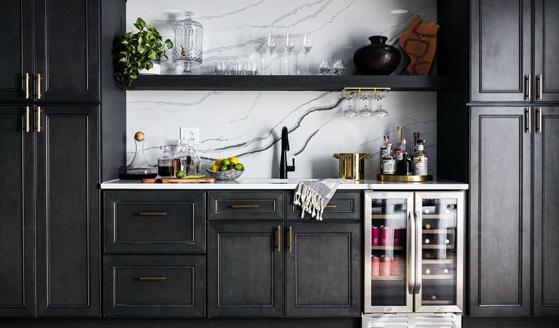 Engineered Wood Panel York Driftwood Grey Cabinets with gold pulls and marble wall 