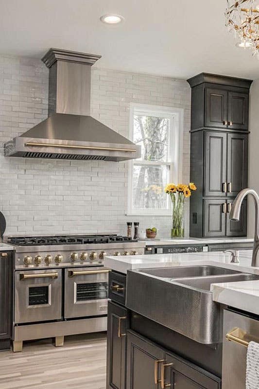 Rustic kitchen design with stainless steel appliances and Farmhouse sink