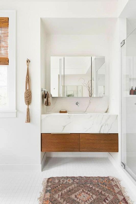 Floating wood bathroom vanity with marble countertops 