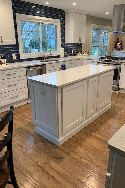 Glass blue backsplash with white cabinets