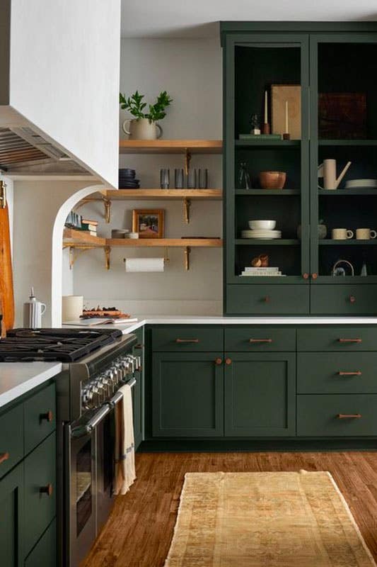 Forest green kitchen cabinets with quartz countertops, Range Hood, and Flouting shelves 