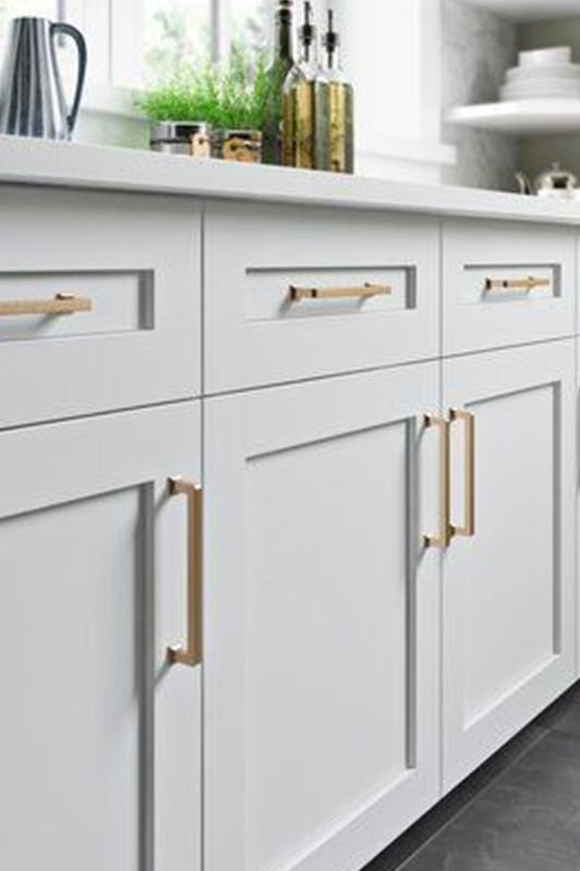 Frameless white cabinets with gold pulls