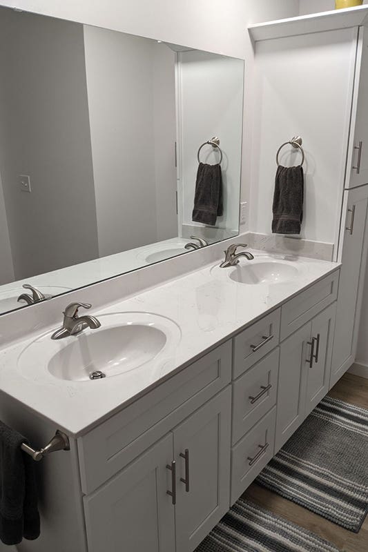 White bathroom design with frameless mirror