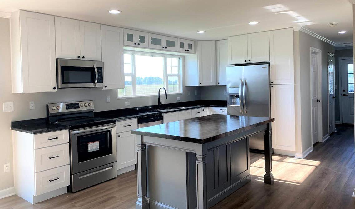 Black and white kitchen with stainless steel appliances 