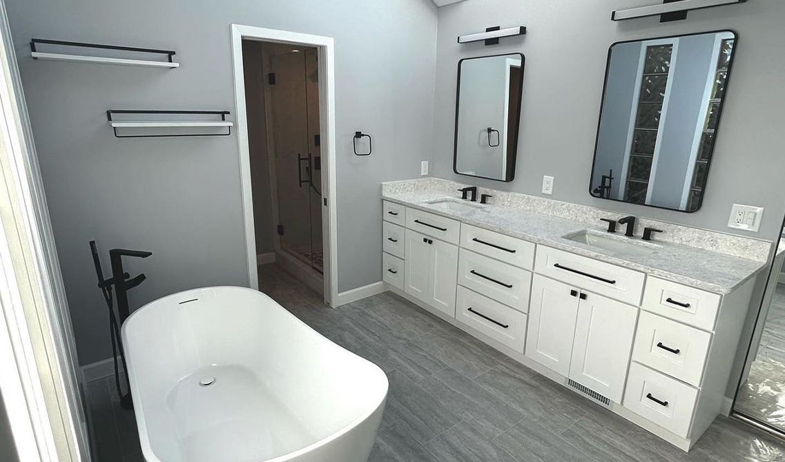 Bathroom design with free standing bathtub and floating shelving 