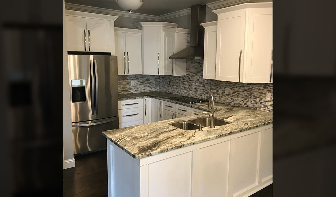 G-shaped kitchen with white cabinets