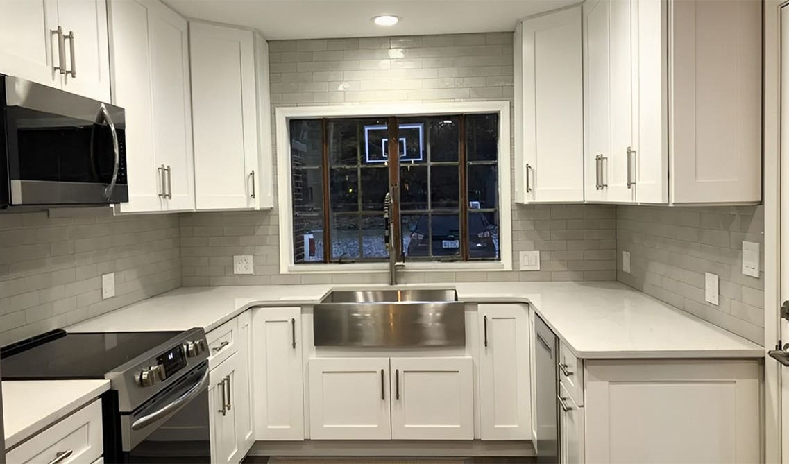 Galley Kitchen Layout features white shaker cabinets and stainless steel appliances