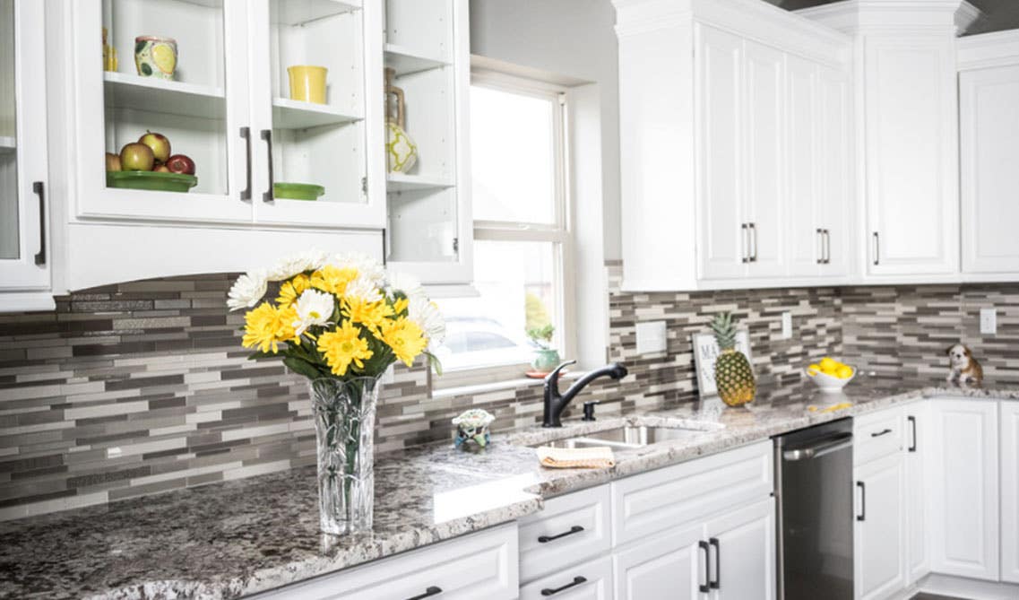 White kitchen cabinets with granite countertops