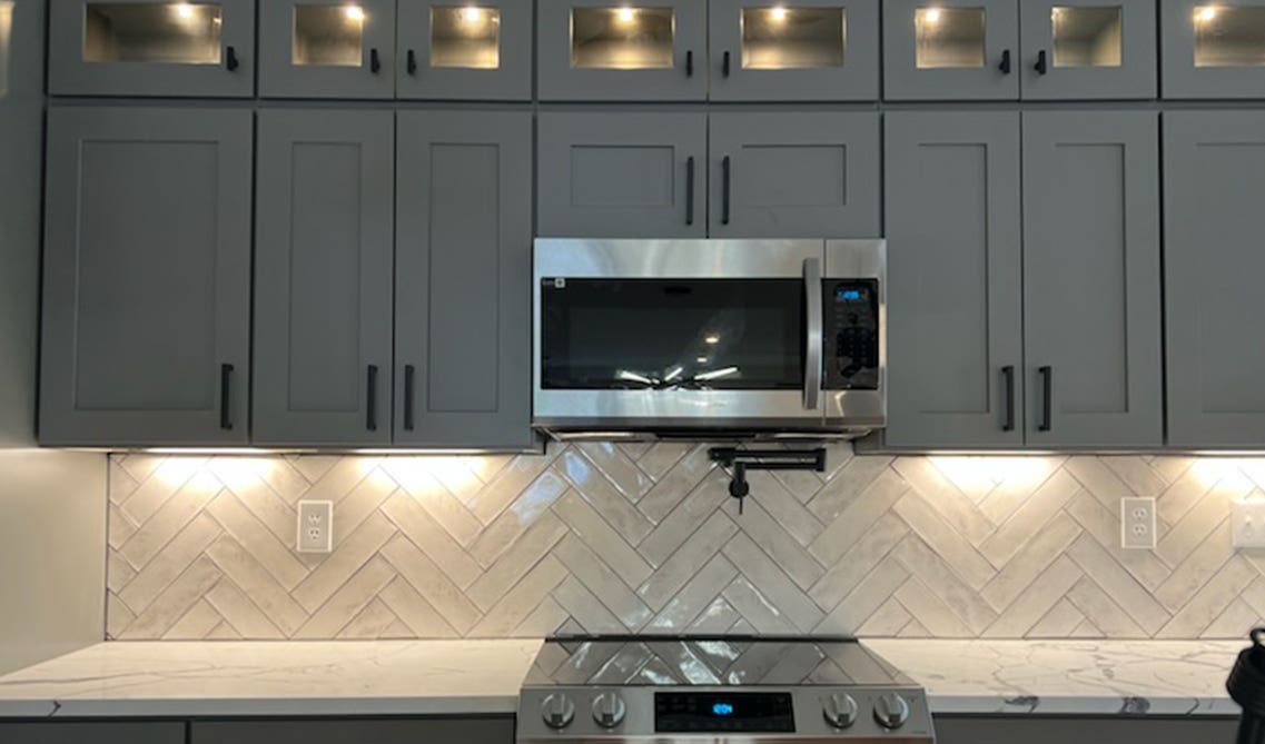 Gray Kitchen Cabinet with under cabinet light