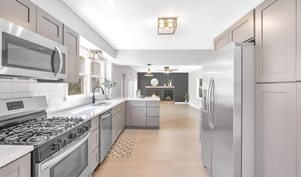 Gray shaker kitchen cabinets paired with stainless steel appliances 