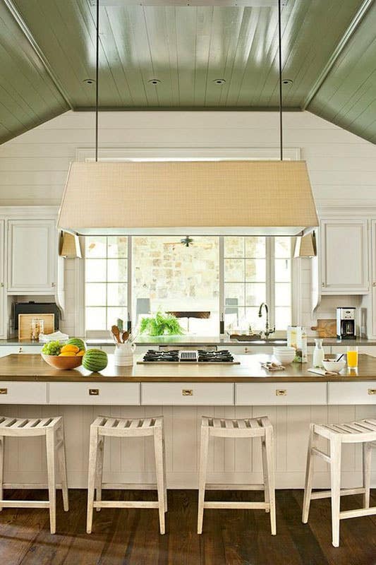 rustic kitchen features with white cabinets, wood countertops and Green Ceilings