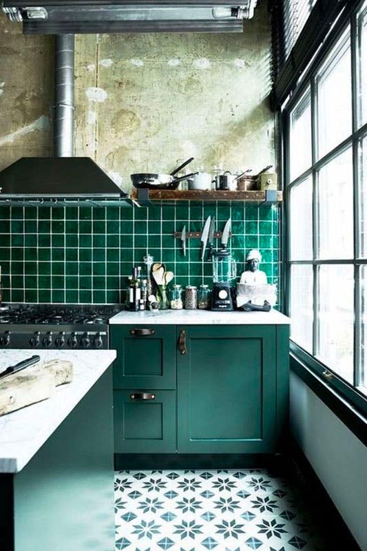 Bold kitchen with green Cabinets, flooring, and backsplash tiles