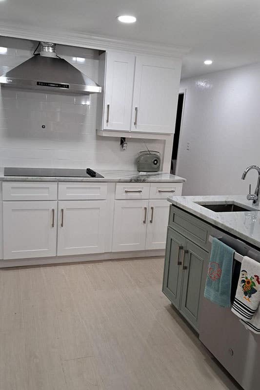 White Shaker Cabinets and green shaker island cabinet