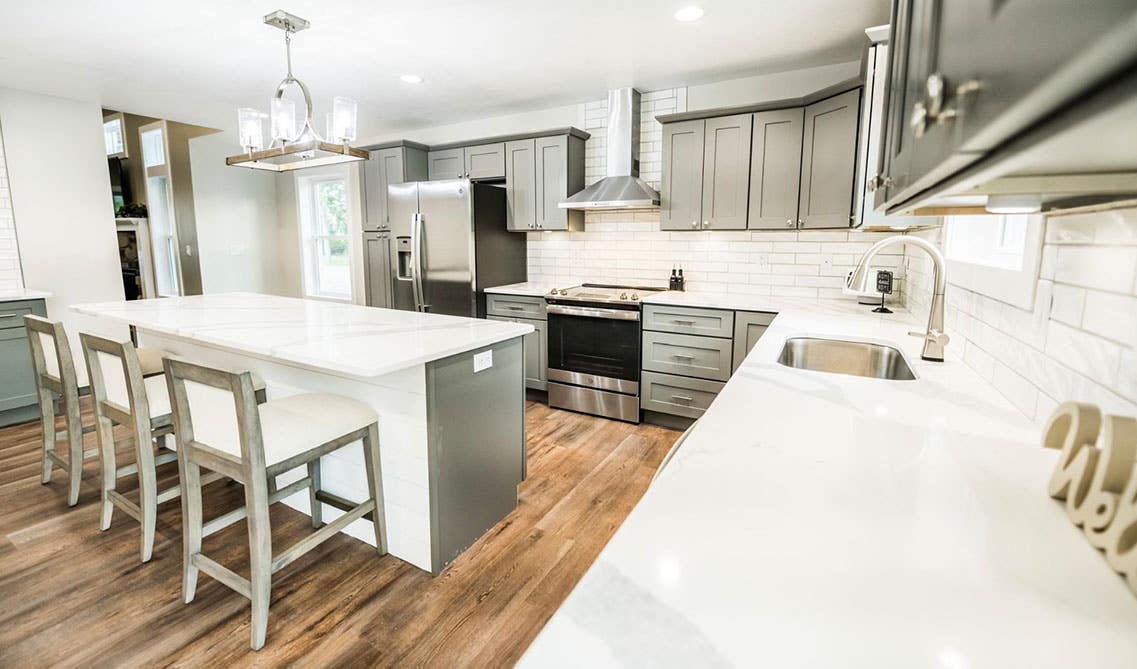 Grey Shaker Elite Cabinets with White Countertop, large island, and Stainless Steel Appliances 