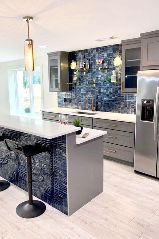Gray shaker cabinets with Bi-Level Kitchen Island and blue color subway tiles