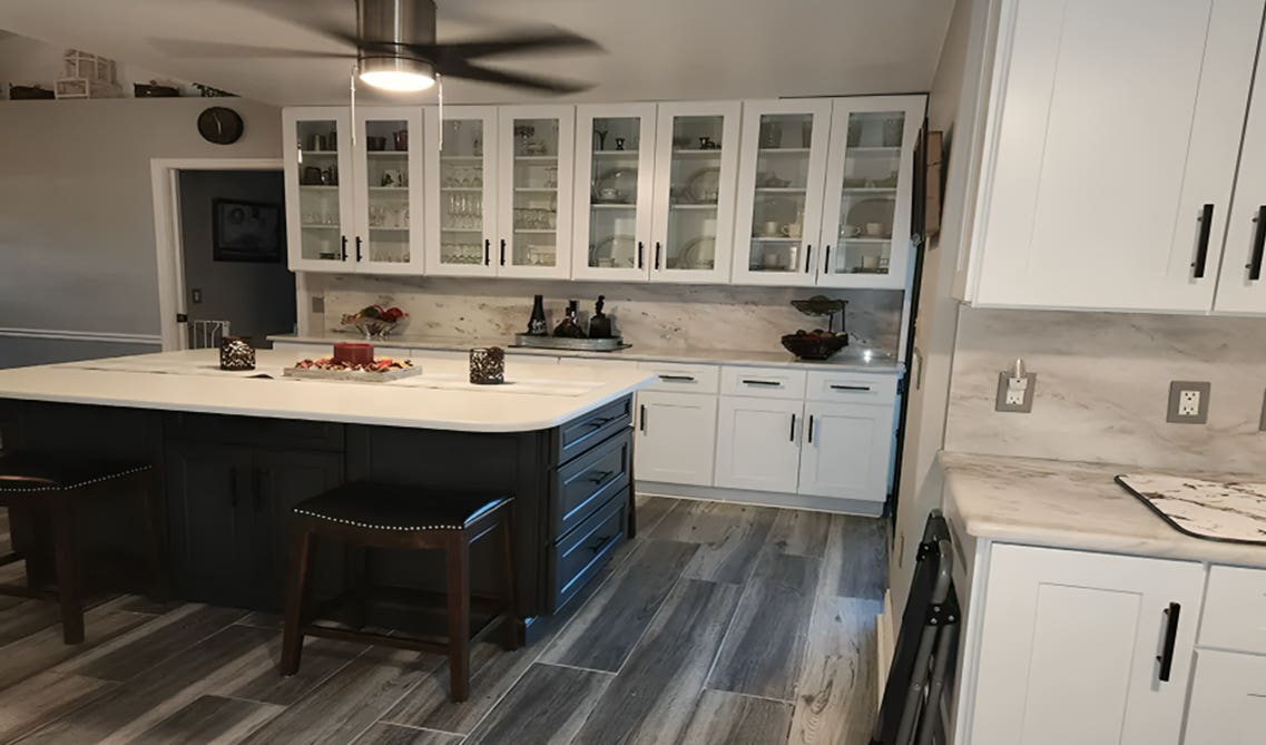 White kitchen cabinets paired with marble backsplash and countertop