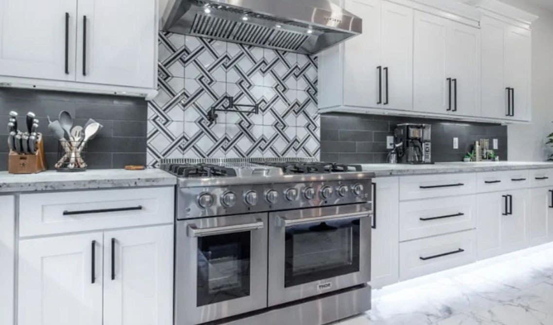 Kitchen with Herringbone Backsplash, white cabinets