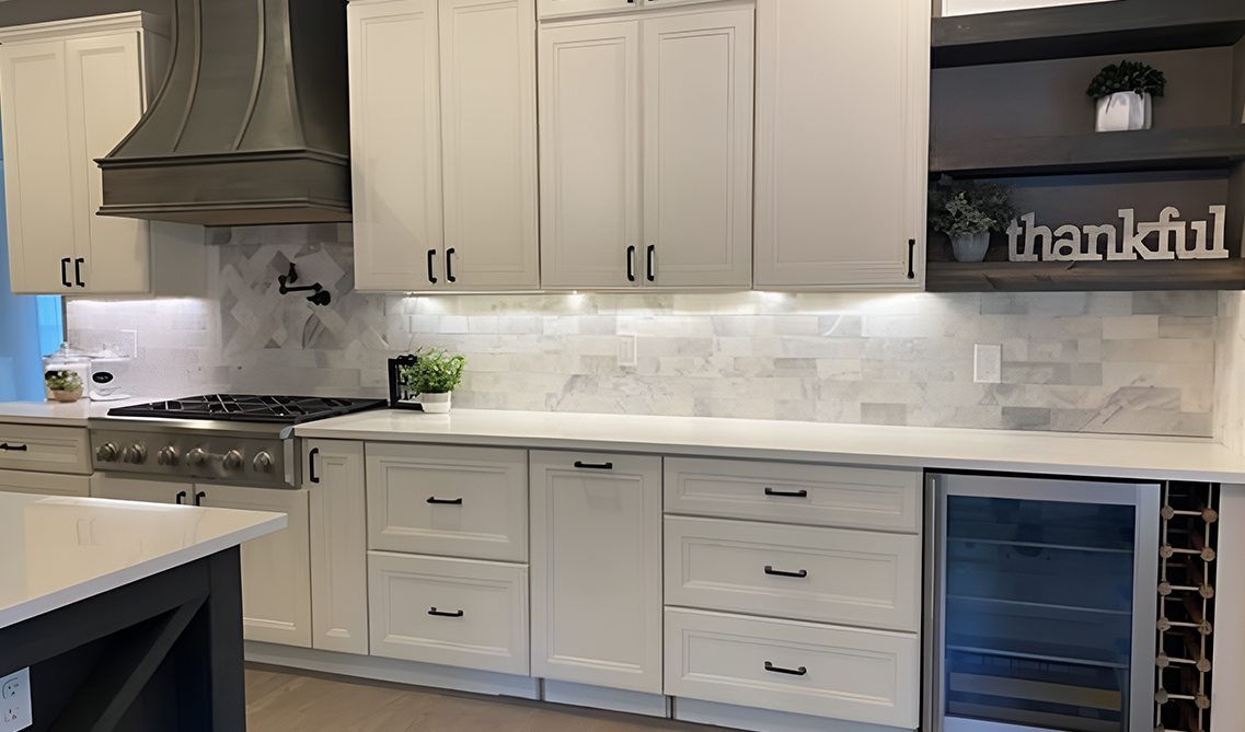 York linen kitchen cabinets paired with black wood hood, matt black pulls and white countertop 