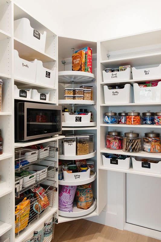 Walk In Pantry with White floating Shelves and Lazy Susans