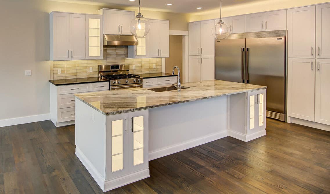 kitchen with white cabinets, marble countertop, spc flooring and Inner Cabinet Lighting