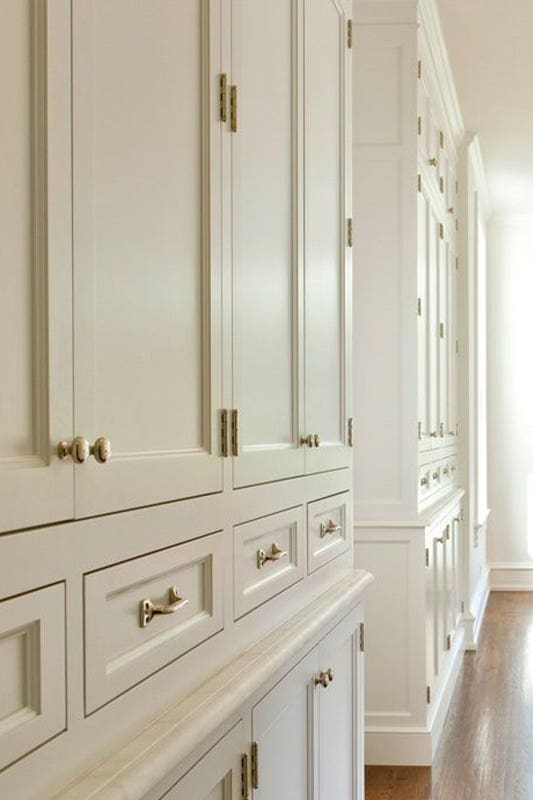 Inset overlay framed cabinets with gold pulls