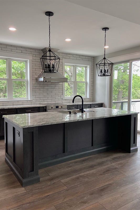 island kitchen layout feature driftwood gray cabinets and pendent lights above island
