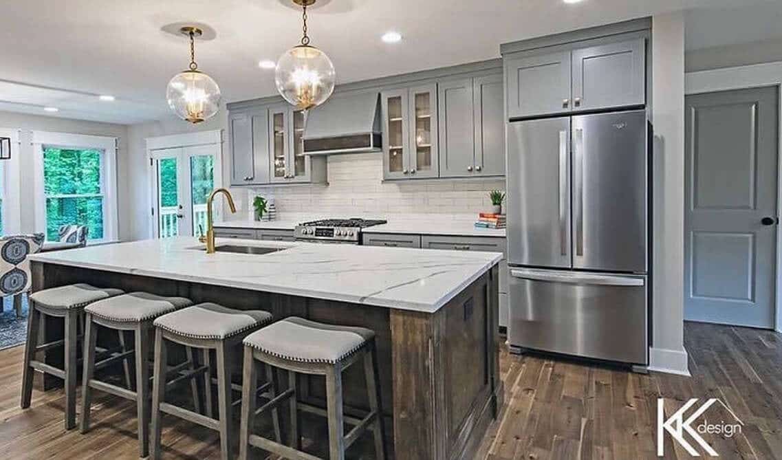 Grey kitchen cabinets with wooden island and single single bowl kitchen sink